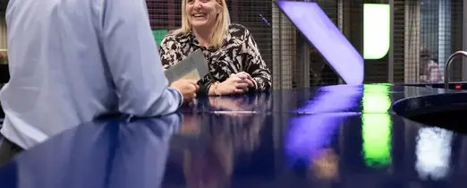 people_colleagues_talking_at_coffee_area_smiling_laughing