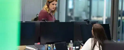 people_colleagues_talking_in_office_infront_of_laptop