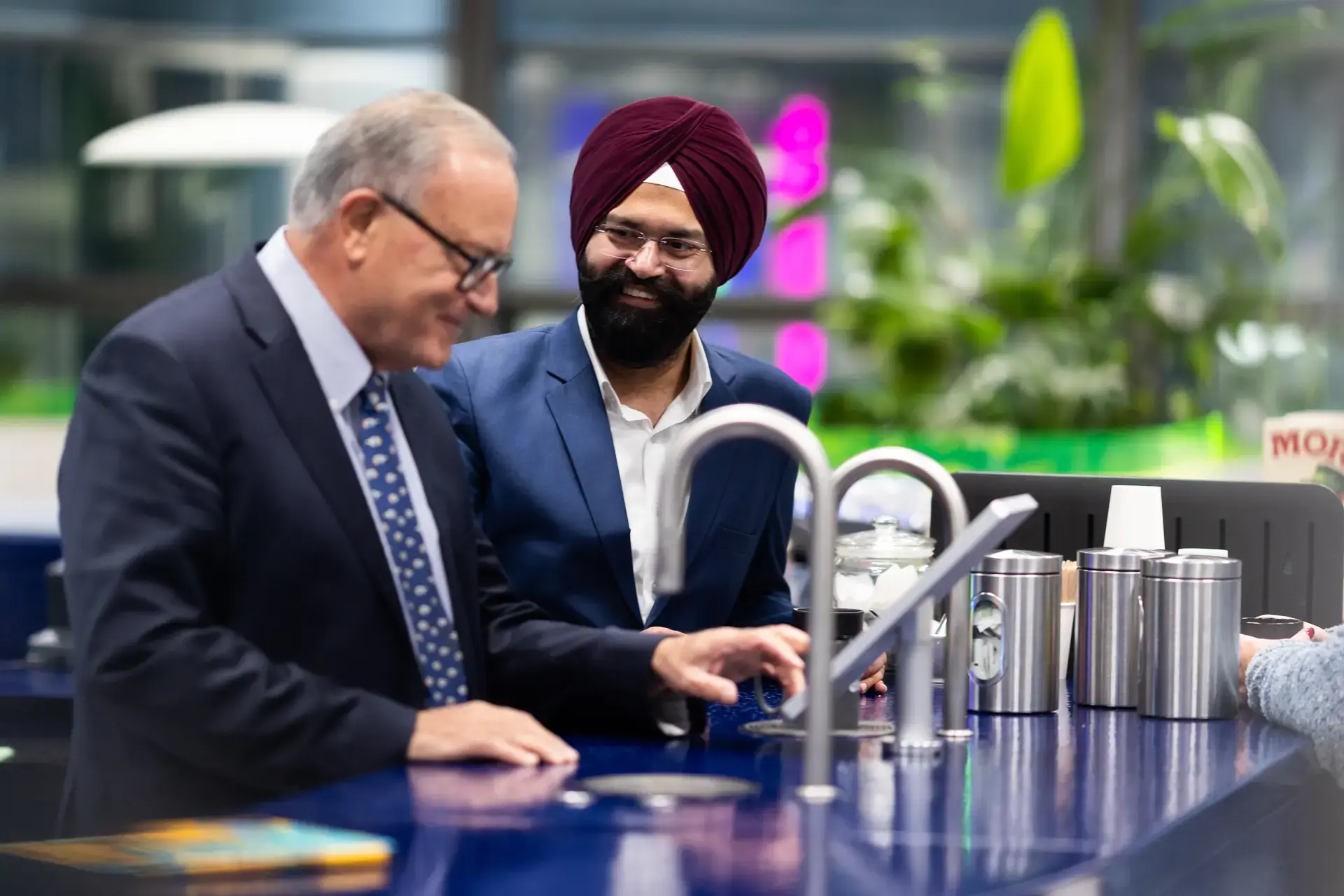 people_colleagues_coffee_area_using_the_machine_