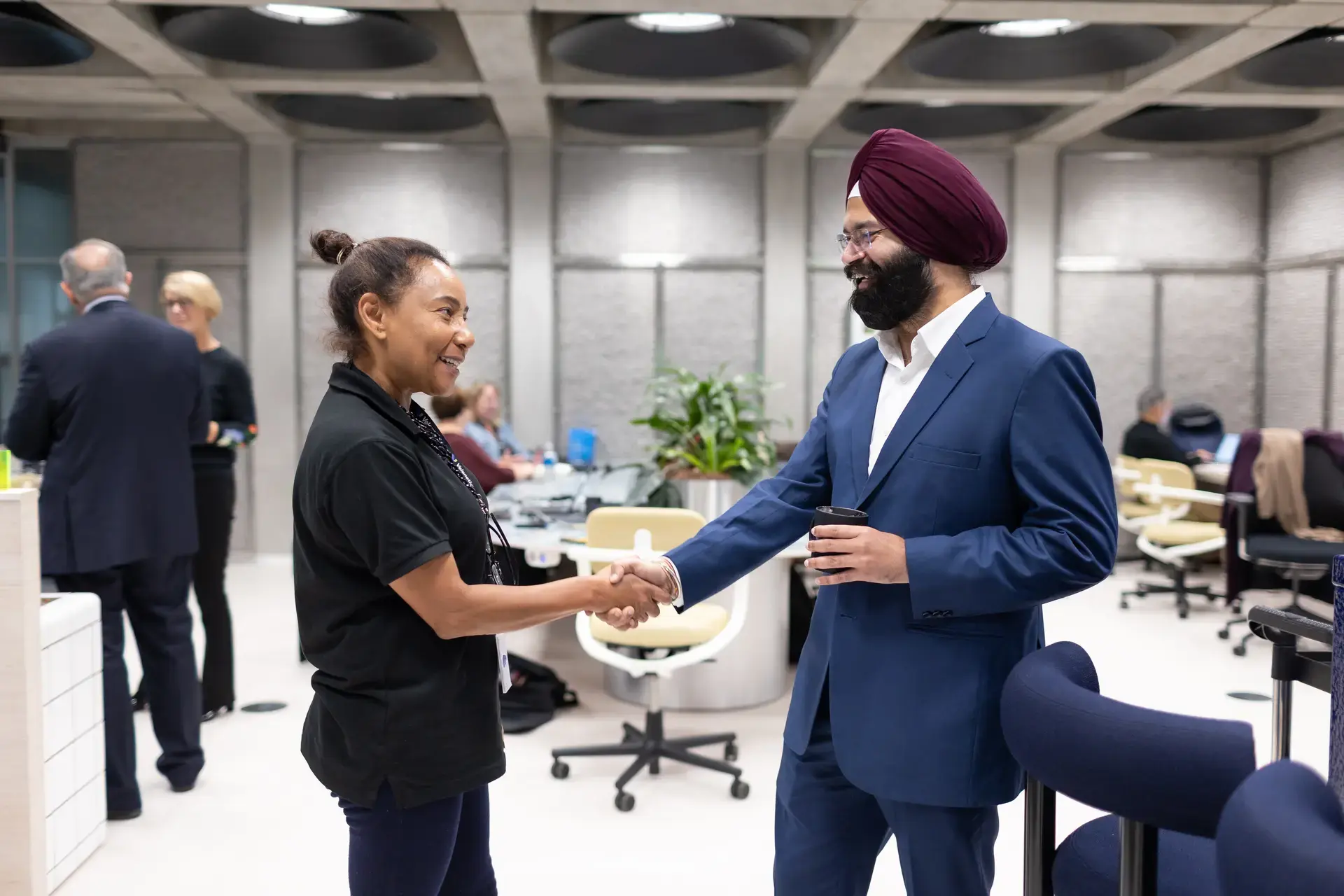 people_colleagues_shaking_hands_in_office