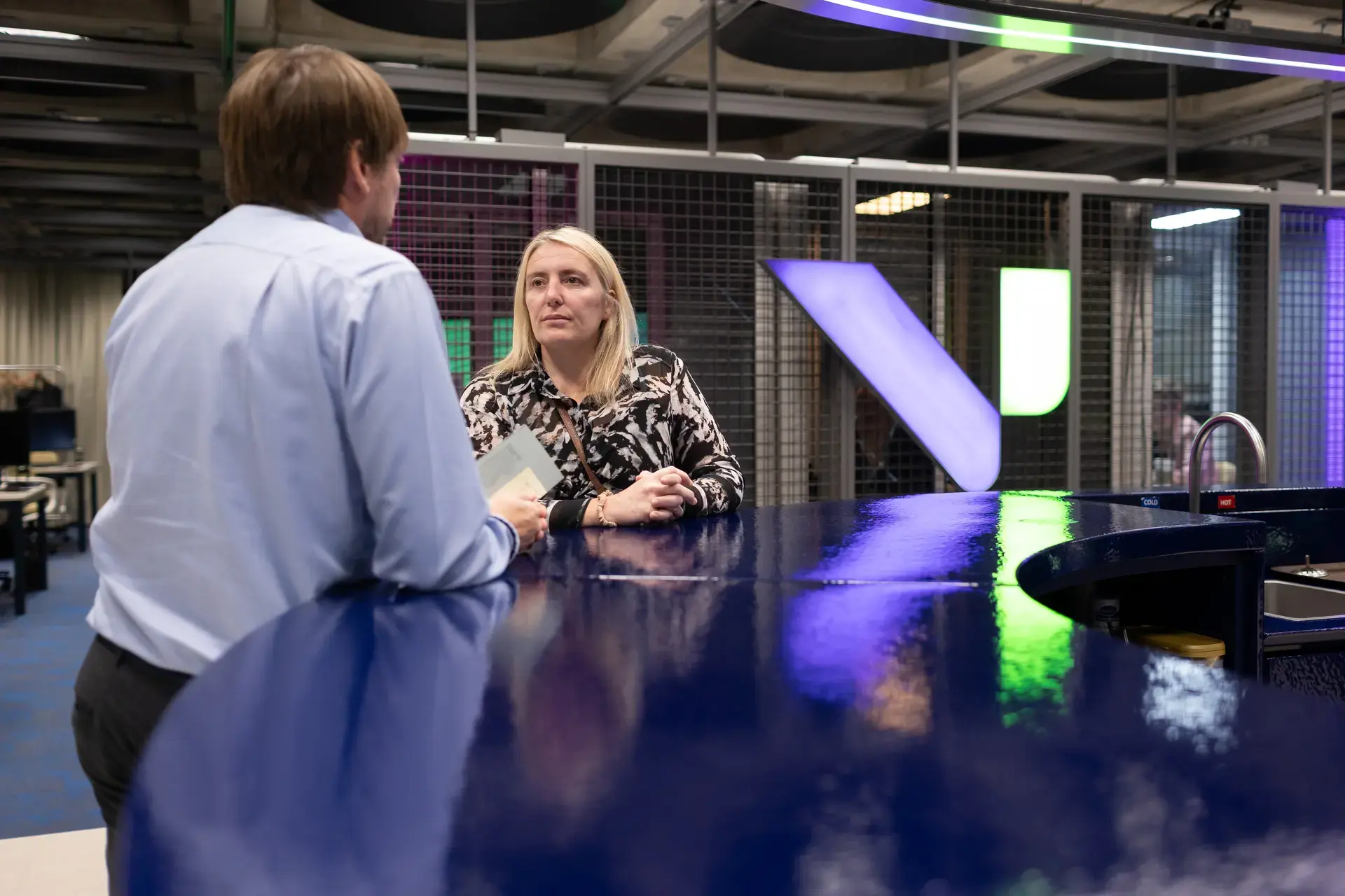 people_colleagues_talking_at_coffee_area_in_office