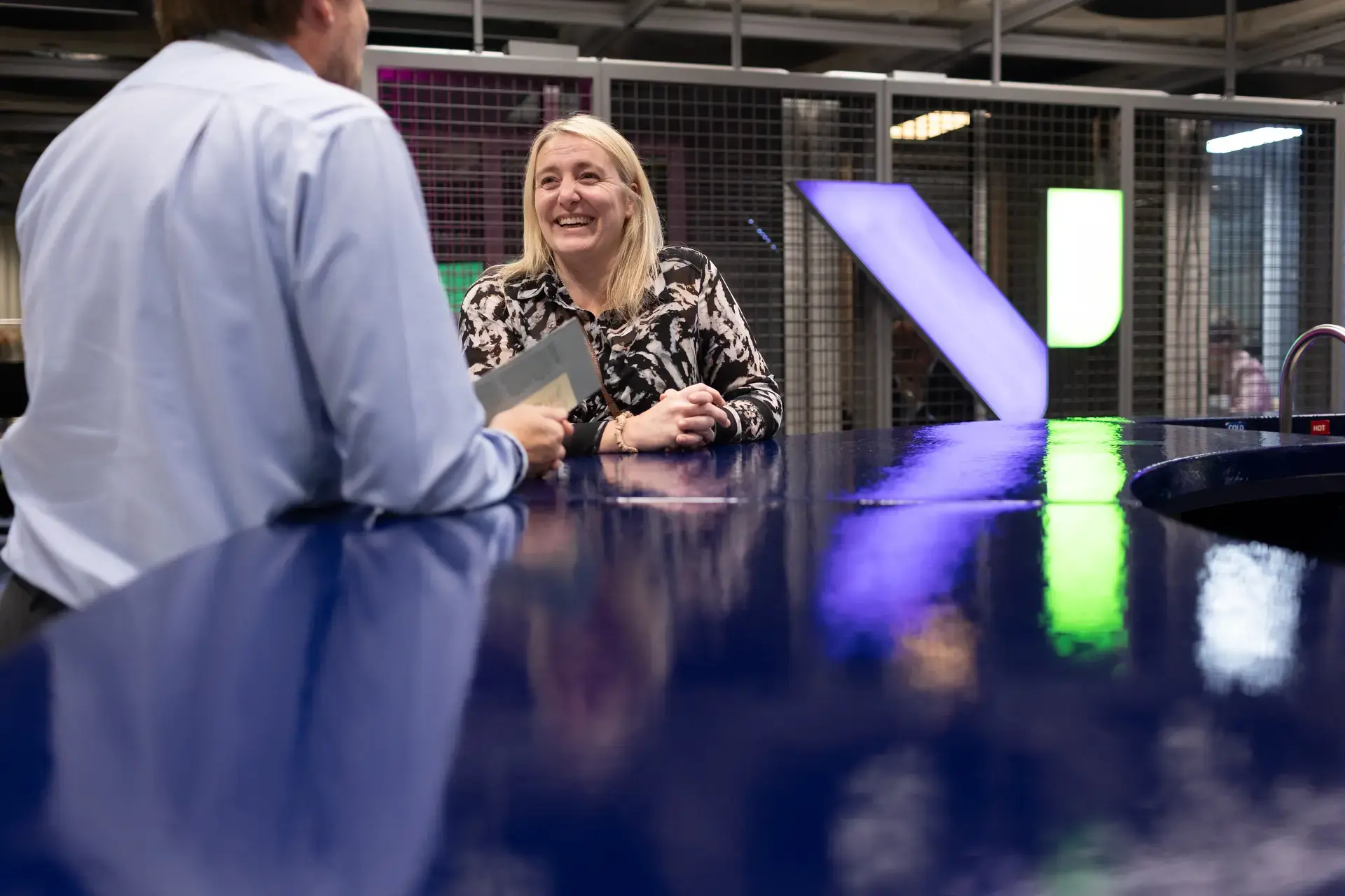 people_colleagues_talking_at_coffee_area_smiling_laughing
