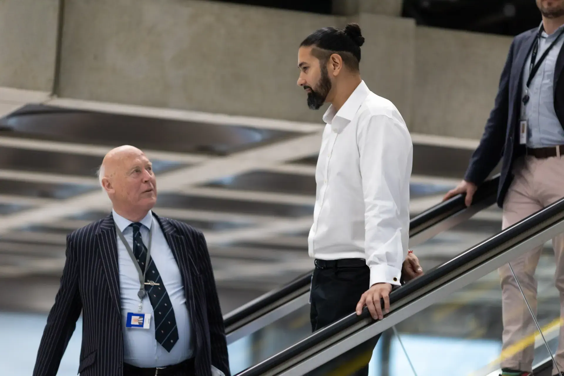 Colleagues talking going down the escalator