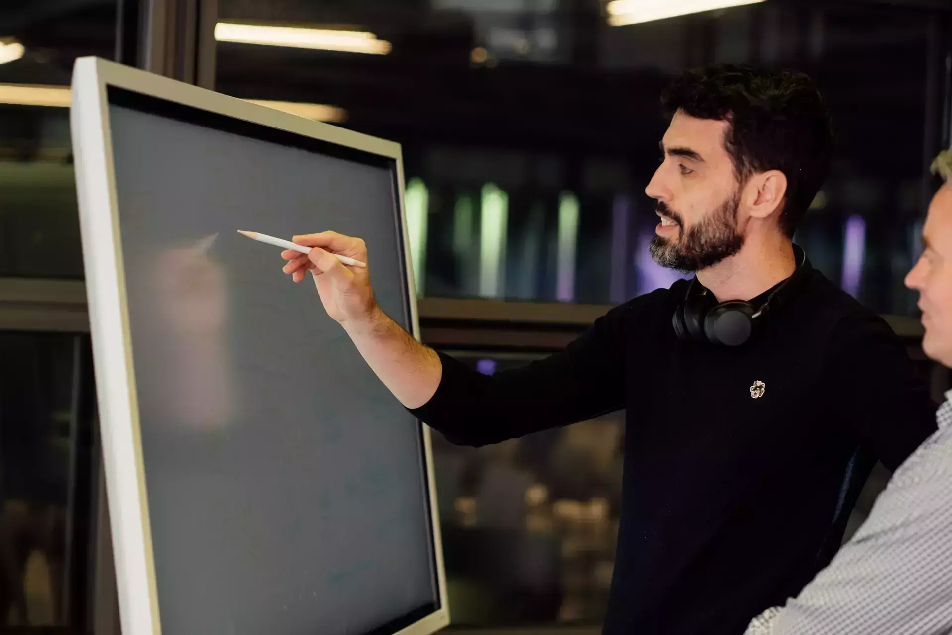 people_man_smiling_and_writing_on_digital_whiteboard