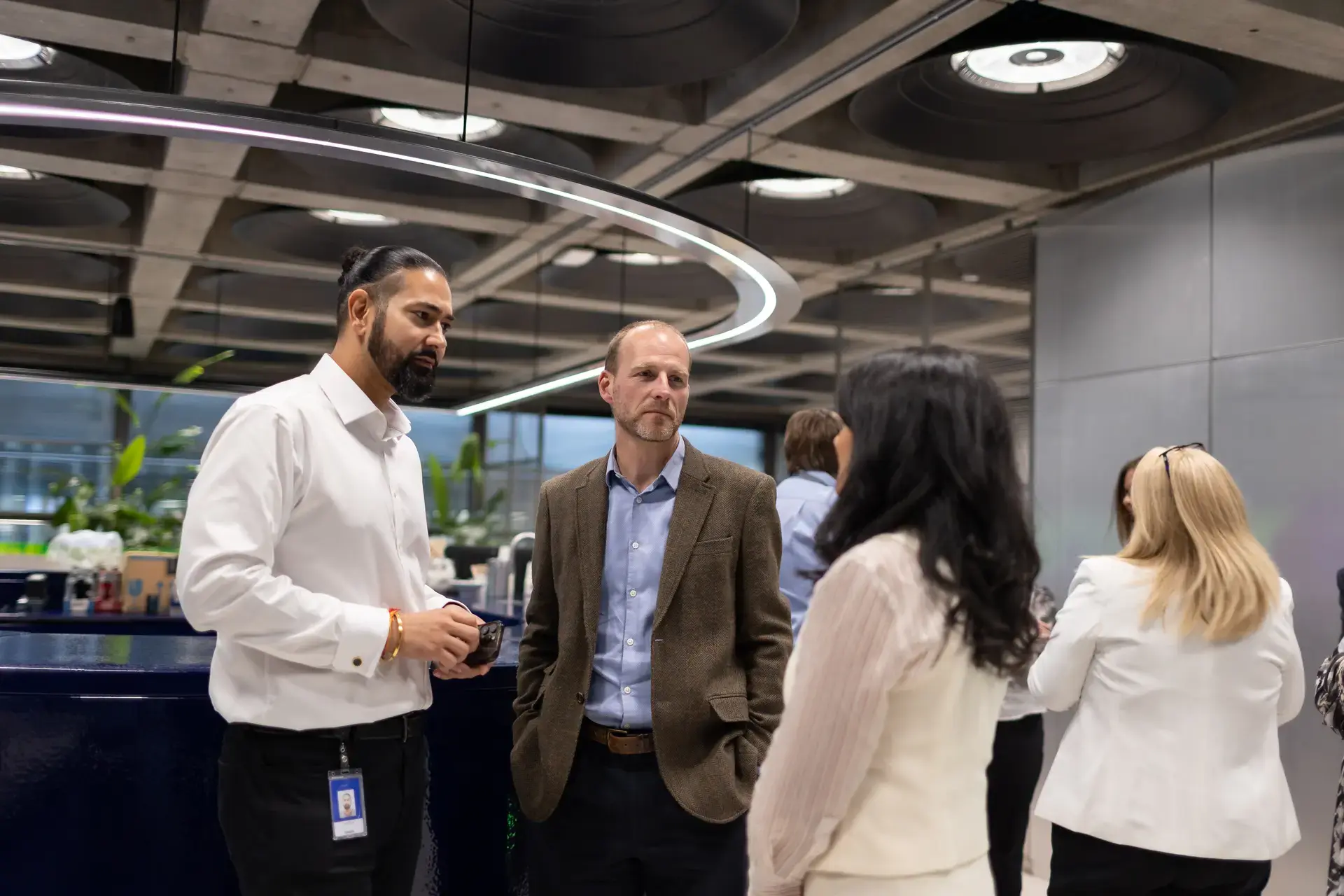 Colleagues chatting at coffee area 